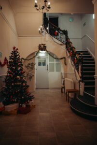 a staircase decorated with christmas decorations and a christmas tree